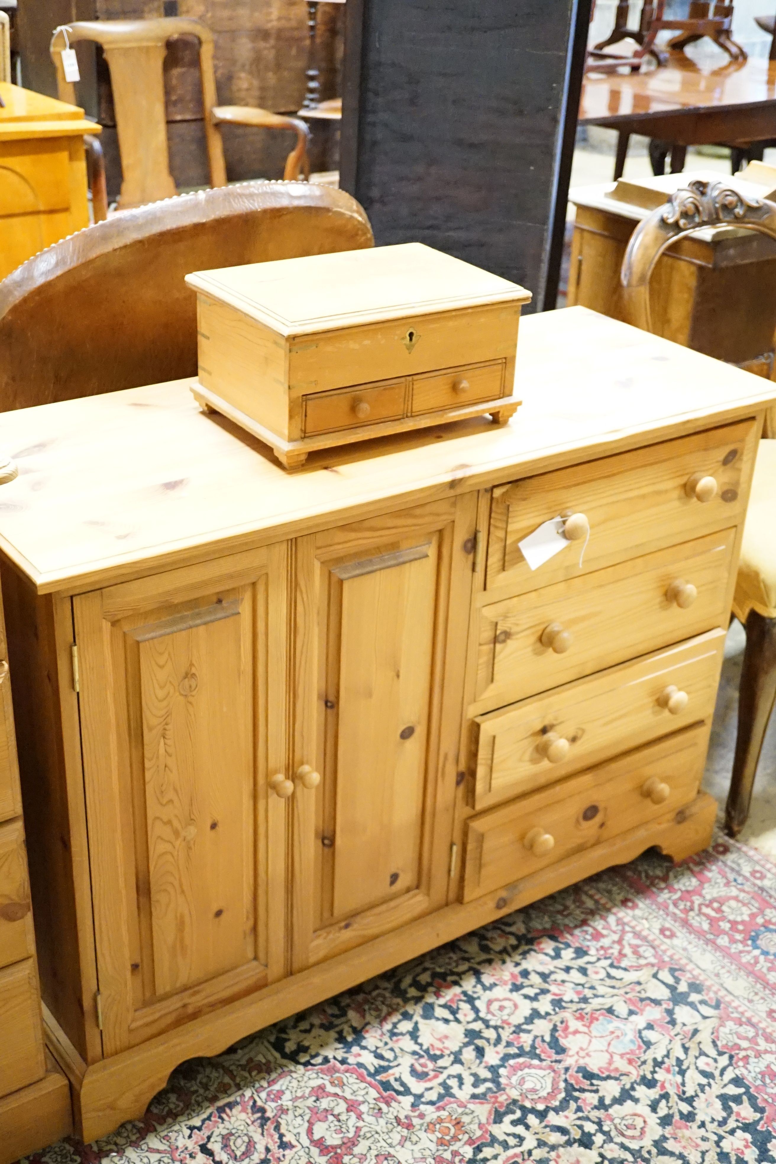 A pine side table, 89cm, a low cabinet, two chests of drawers, a pair of bedside tables, a mirror and jewellery box (8)